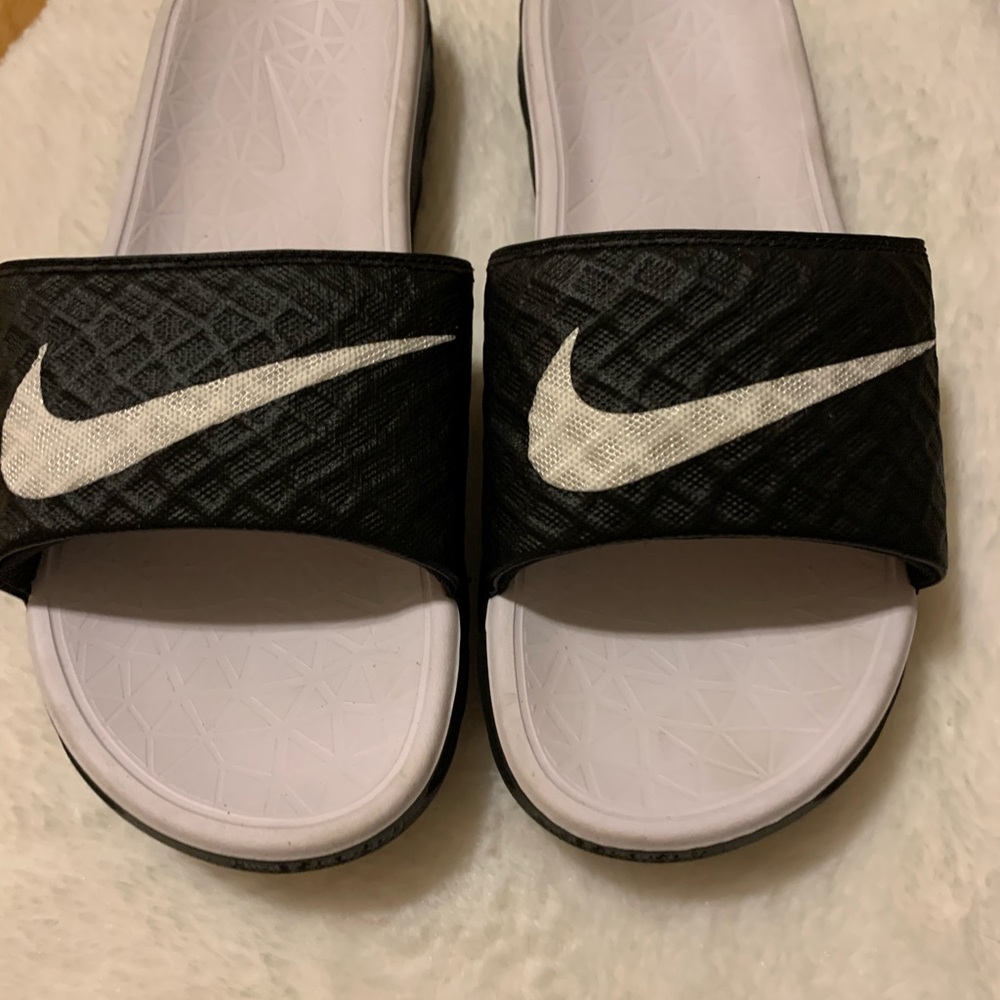 Women’s black and white Nike slides